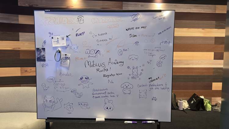 A NOVA Border whiteboard covered in cute doodles and messages left by ARCHIDEX 2026 visitors